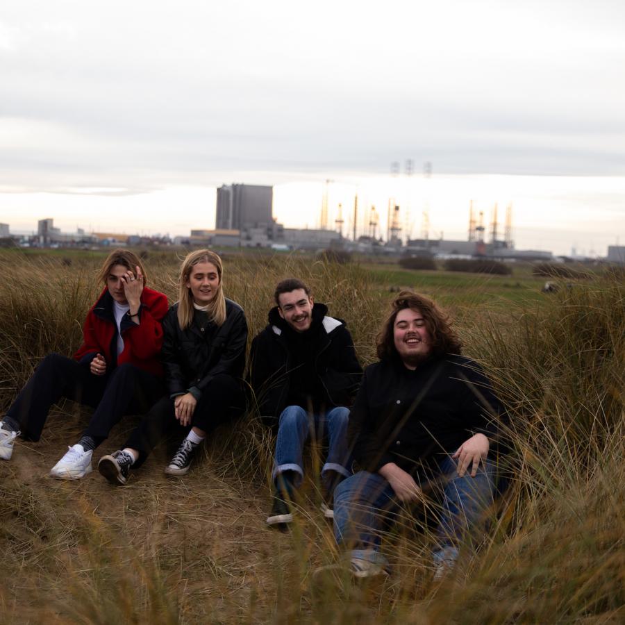 The band sat on a sand dune