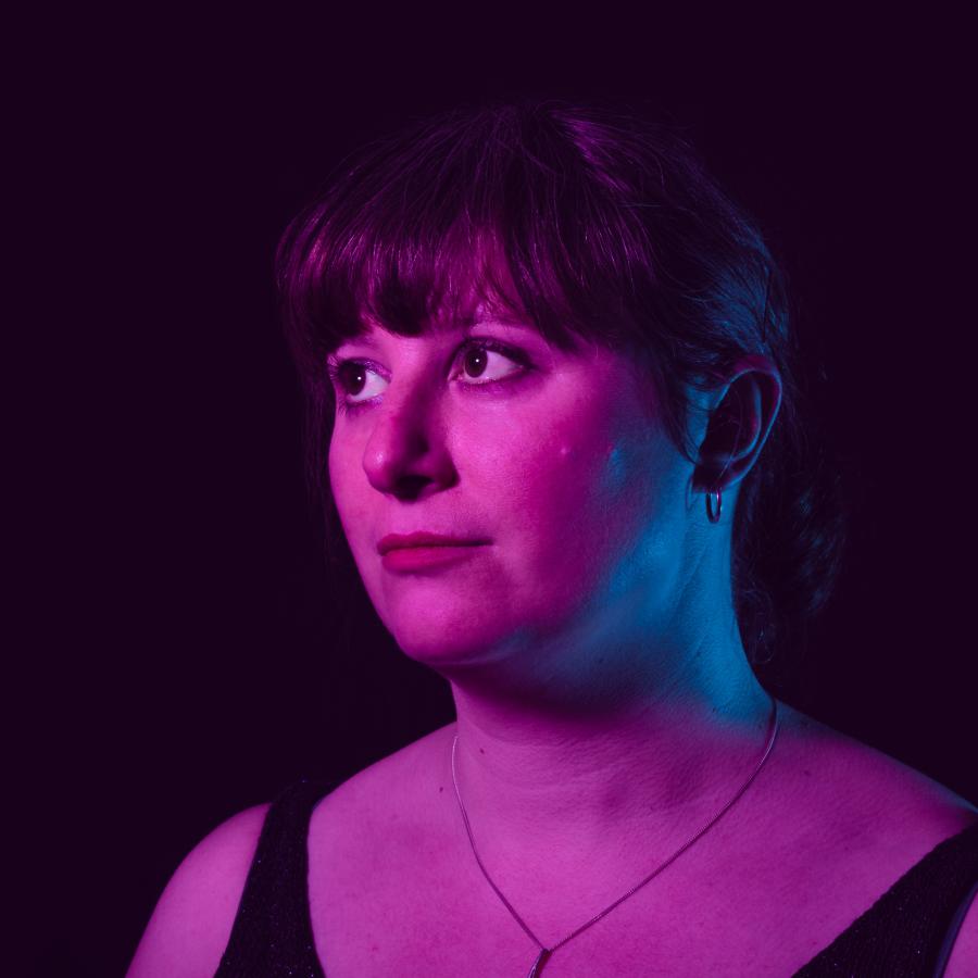 portrait photo woman with fringe in purple light